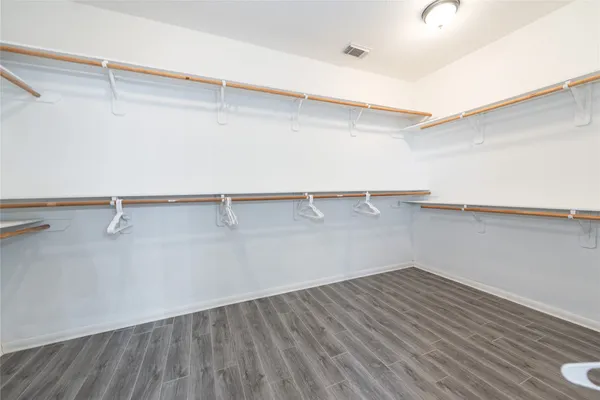 a view of a room with wooden floor