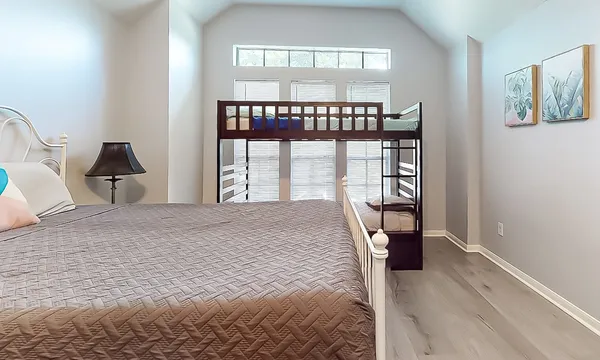 a bedroom with a bed and a large window
