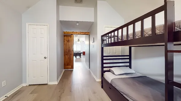 a hallway with stairs and wooden floor