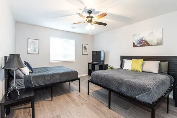 a bedroom with a bed and a chandelier