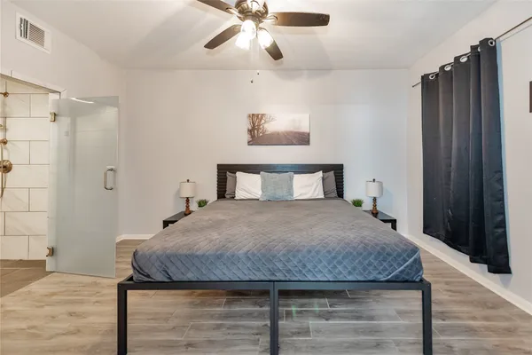 a bedroom with a bed and wooden floor