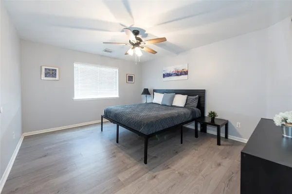 a bedroom with a bed window and a table
