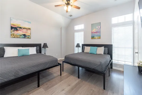 a bedroom with a bed a table and a painting on the wall