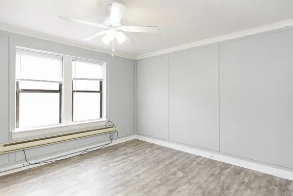 a view of room with window and ceiling fan