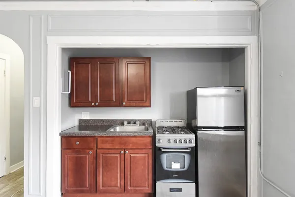 a kitchen with stainless steel appliances granite countertop a refrigerator and a stove top oven