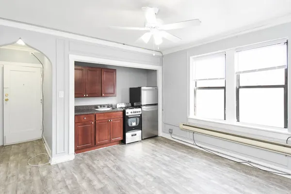a open kitchen with granite countertop a refrigerator and a sink