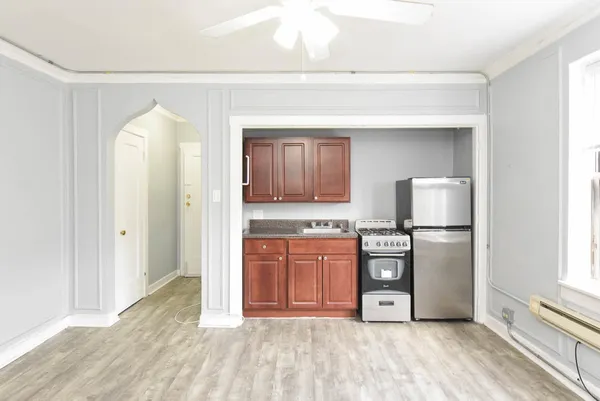 a kitchen with stainless steel appliances granite countertop a refrigerator and a stove top oven