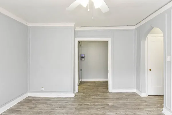 a view of an empty room with wooden floor
