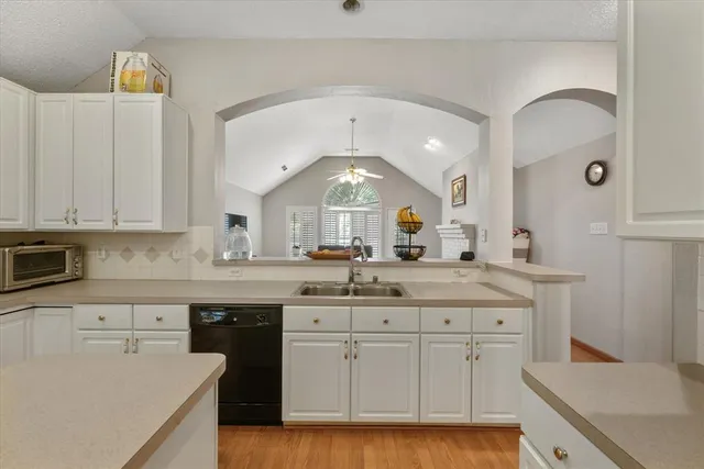 a kitchen with a sink cabinets and window