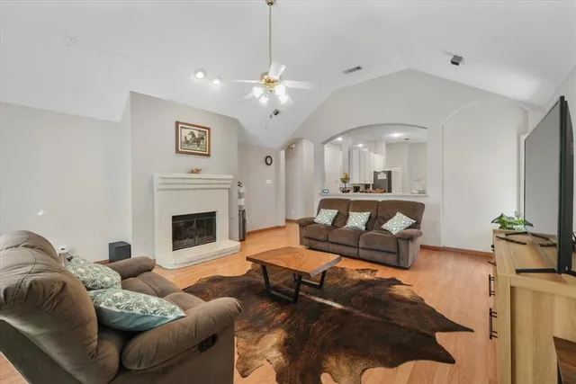 a living room with furniture fireplace and a chandelier