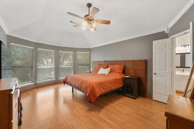 a bed sitting in a bedroom next to a window