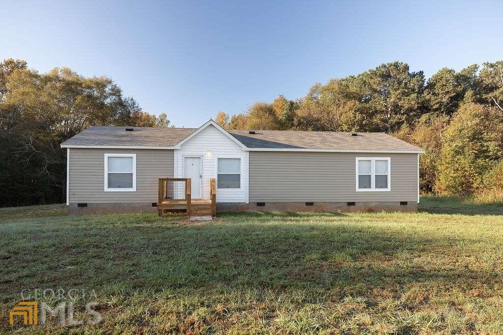 375 Beck Road Hull, GA 30646 - Photo 1 of 1 a front view of house with yard and trees in the background