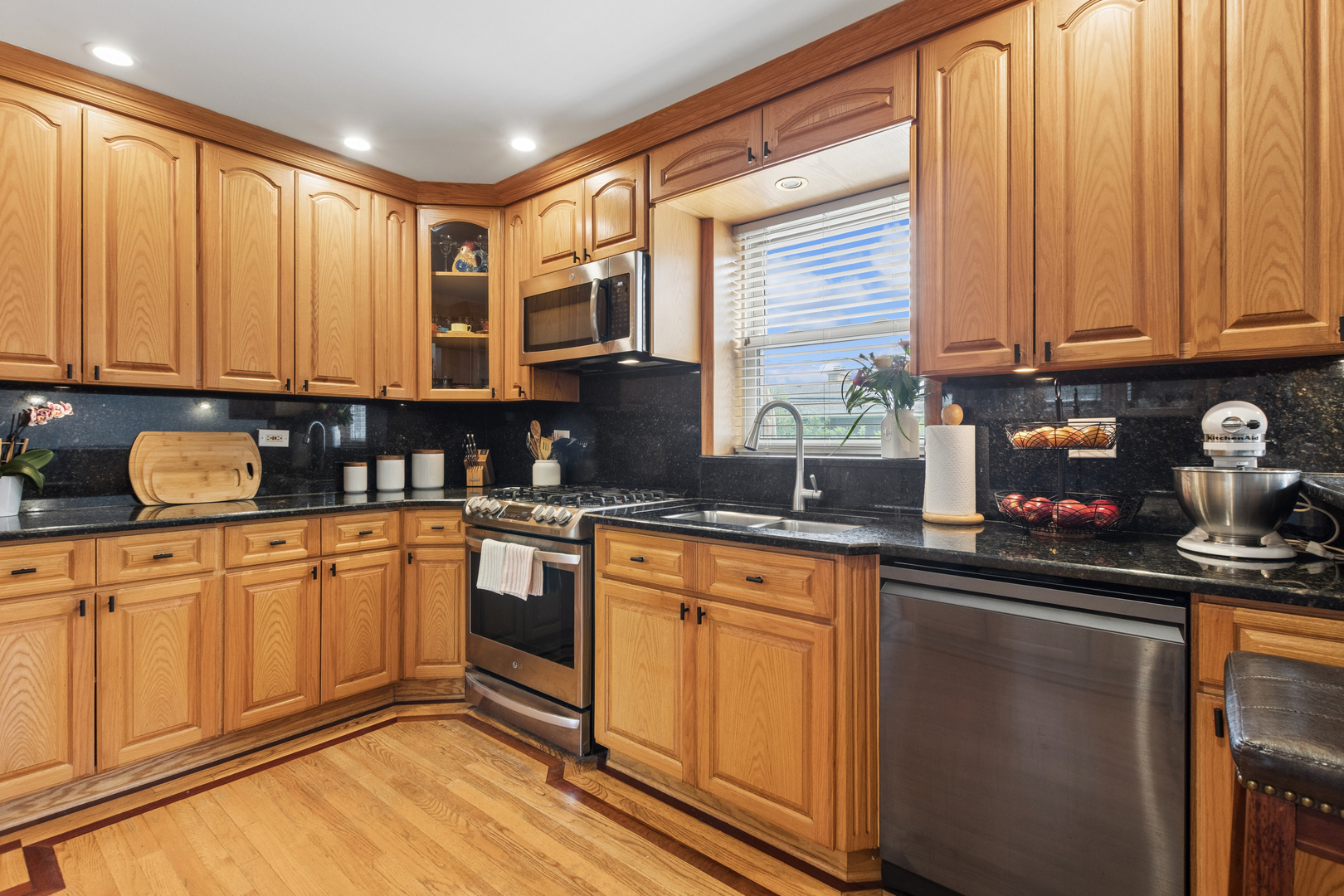 7911 West Rascher Avenue Chicago, IL 60656 - Photo 18 of 39 a kitchen with stainless steel appliances granite countertop a stove a sink and a microwave