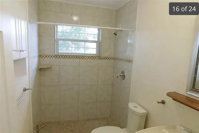 a bathroom with a toilet sink and shower