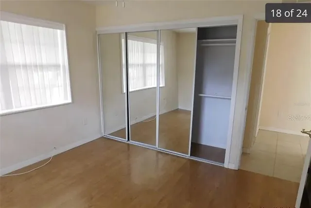 an empty room with windows and closet