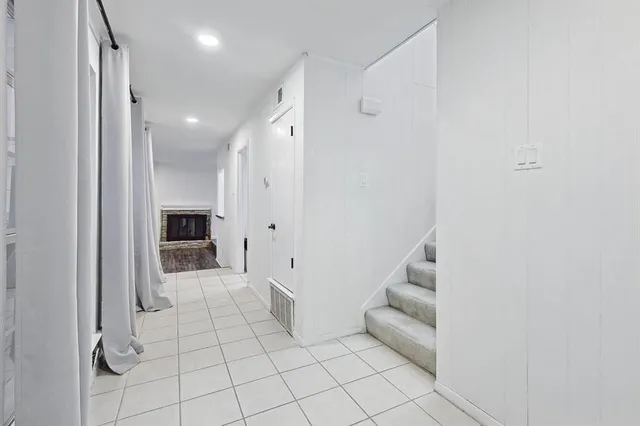 a view of an empty room and a bathroom