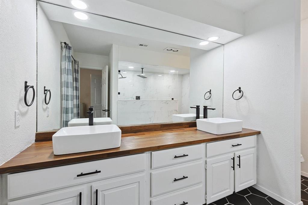 9801 Smokefeather Lane Dallas, TX 75243 - Photo 20 of 27 a bathroom with a sink and a mirror