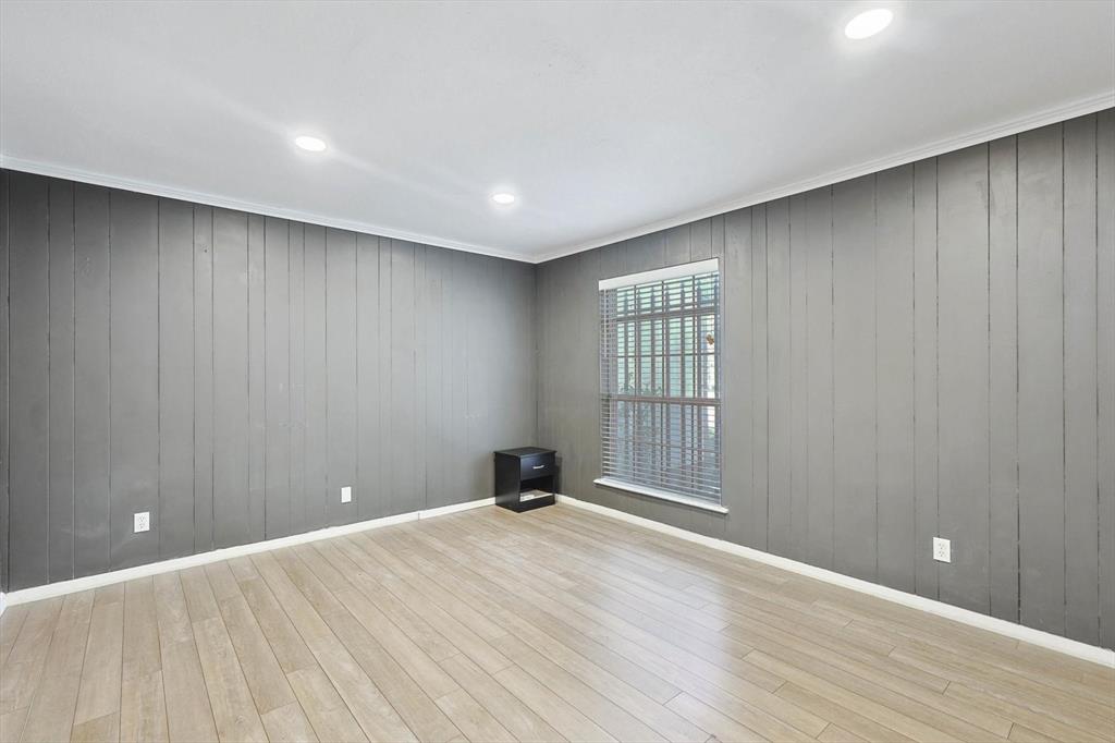 9801 Smokefeather Lane Dallas, TX 75243 - Photo 22 of 27 a view of an empty room with wooden floor and a window
