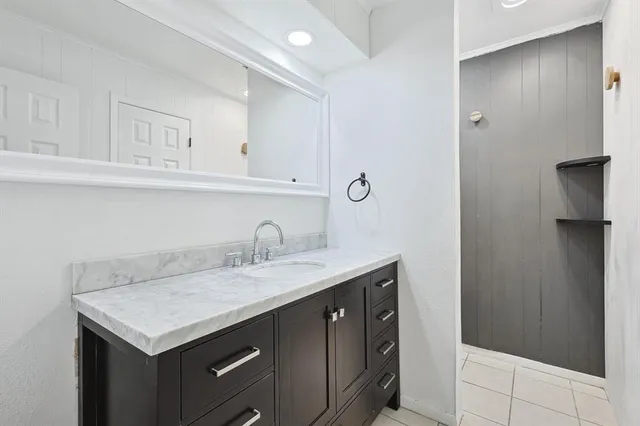 a kitchen with a sink a refrigerator and cabinets