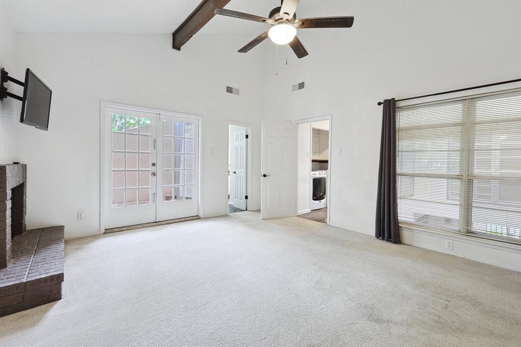 9801 Smokefeather Lane Dallas, TX 75243 - Photo 10 of 27 an empty room with windows and ceiling fan