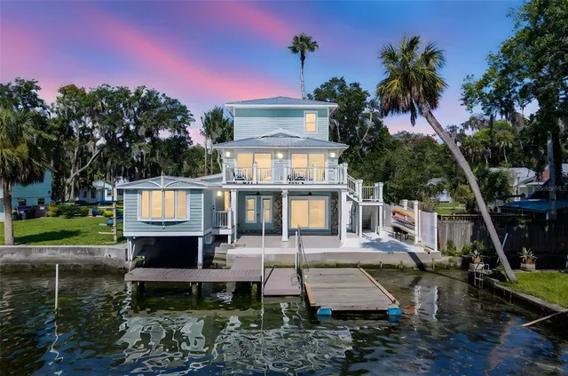 an aerial view of a house with a lake view