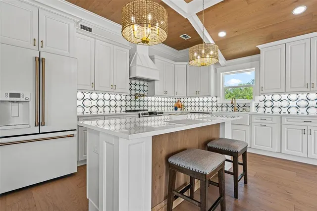 a room with a bed and a chandelier fan