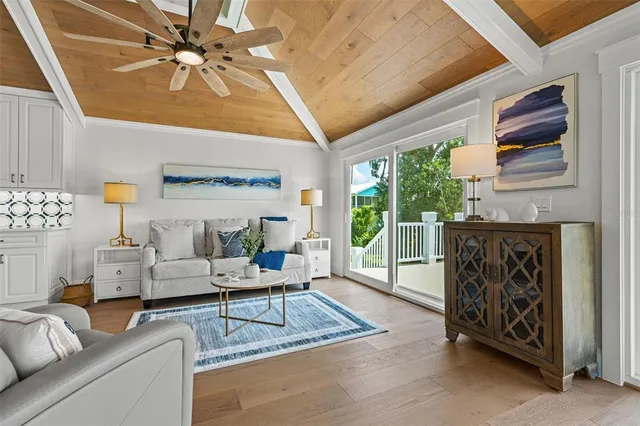 a view of hallway with stairs and wooden floor