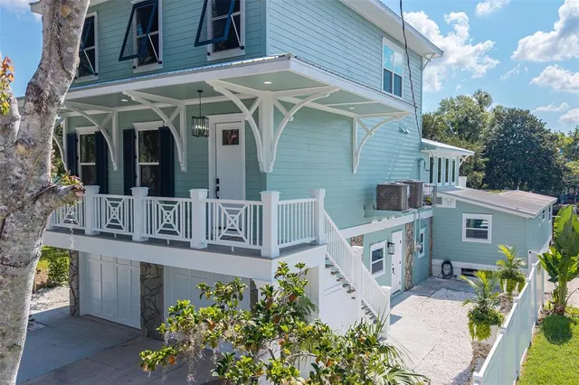 an aerial view of a house with a yard and lake view