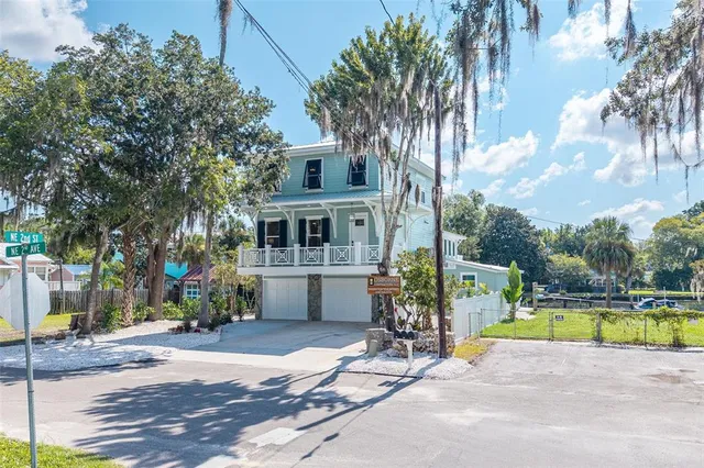 an aerial view of residential houses with outdoor space and river