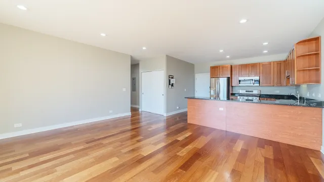 a view of kitchen with kitchen island and stainless steel appliances