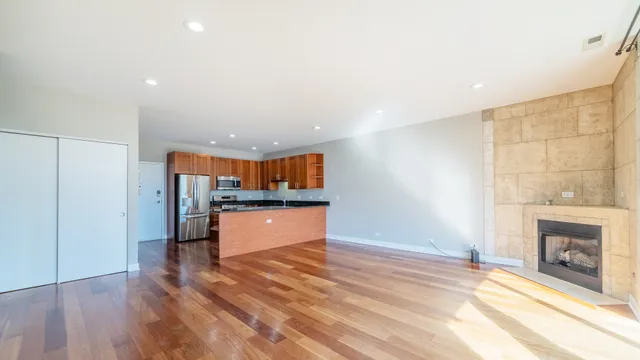 a view of a kitchen with a sink and a fireplace