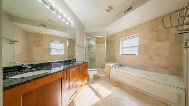 a spacious bathroom with a granite countertop tub sink and mirror