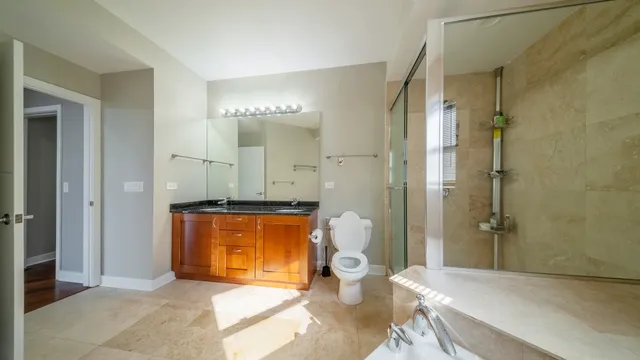 a bathroom with a sink a toilet and shower