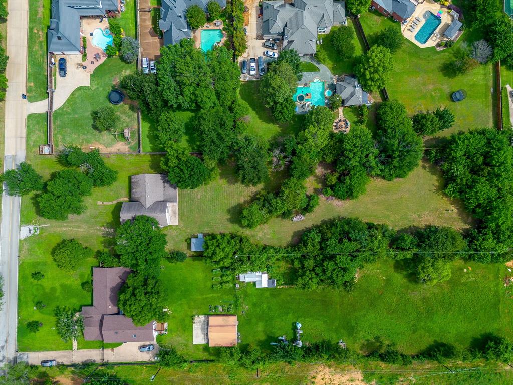 7404 John McCain Road Colleyville, TX 76034 - Photo 4 of 21 an aerial view of residential house with outdoor space and trees all around