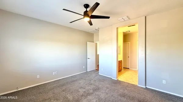a view of a room with a ceiling fan