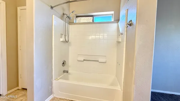 a bathroom with a bathtub with a shower