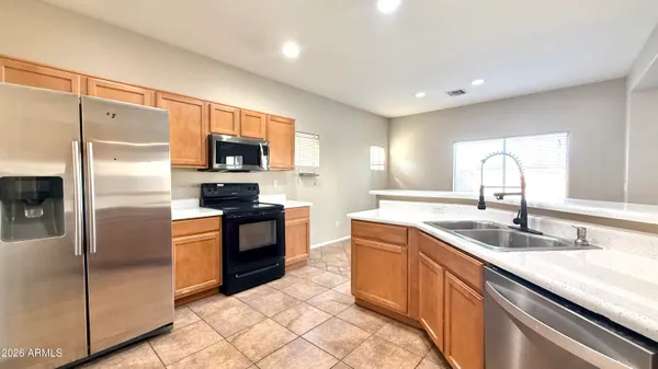 a kitchen with a sink refrigerator and microwave