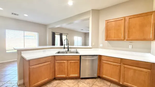 a kitchen with white cabinets sink and window