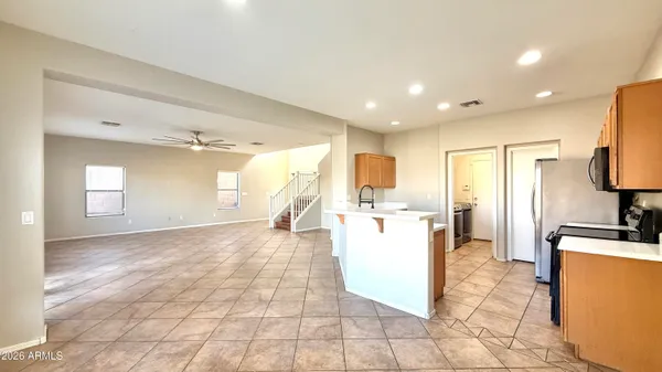a view of a kitchen with a sink a refrigerator and a stove