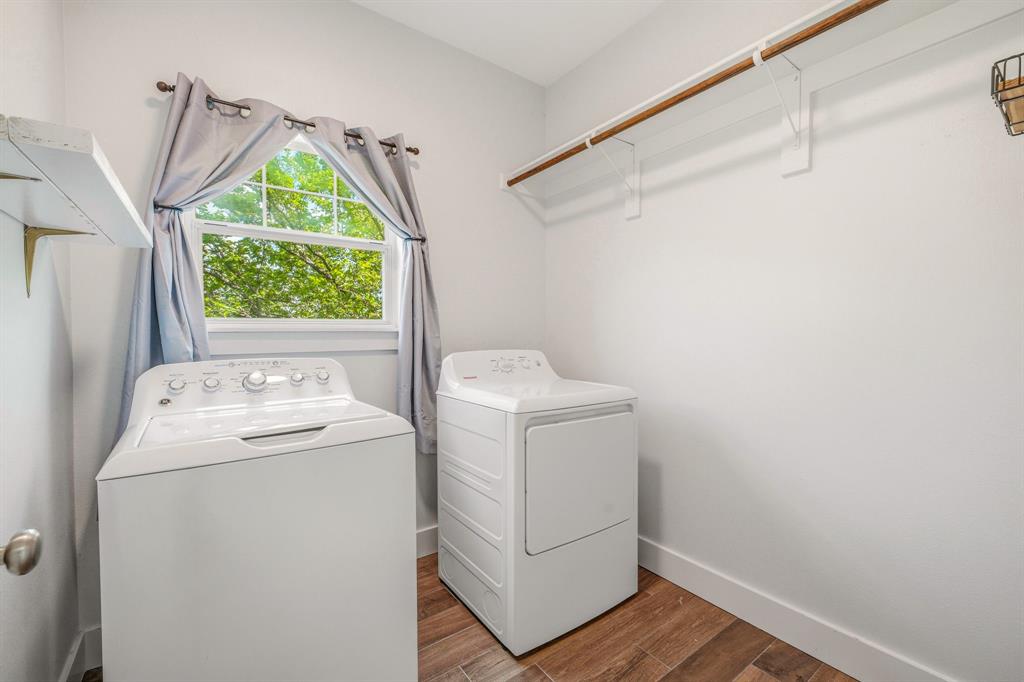 745 North Miller Avenue Stephenville, TX 76401 - Photo 27 of 31 Dedicated laundry area featuring wood-finish flooring, a white window frame, and a wall-mounted wooden hanging rod with shelving