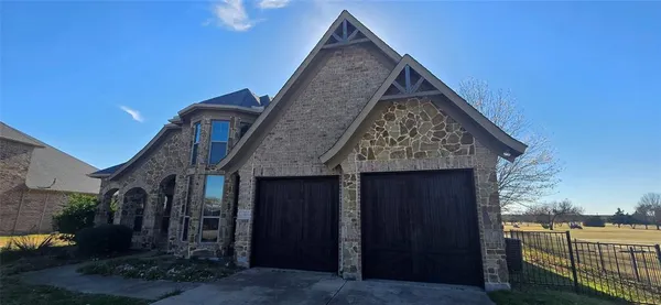 a view of a house with wooden fence