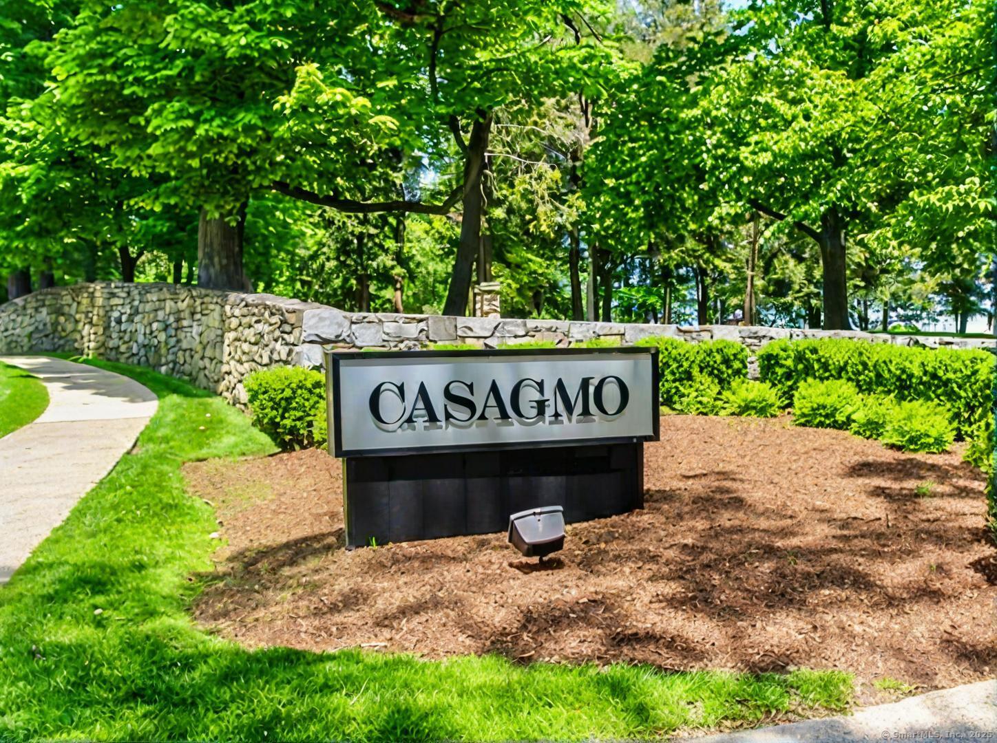 a view of a street sign under a large tree