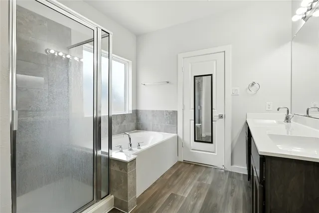 a bathroom with a bathtub and a sink