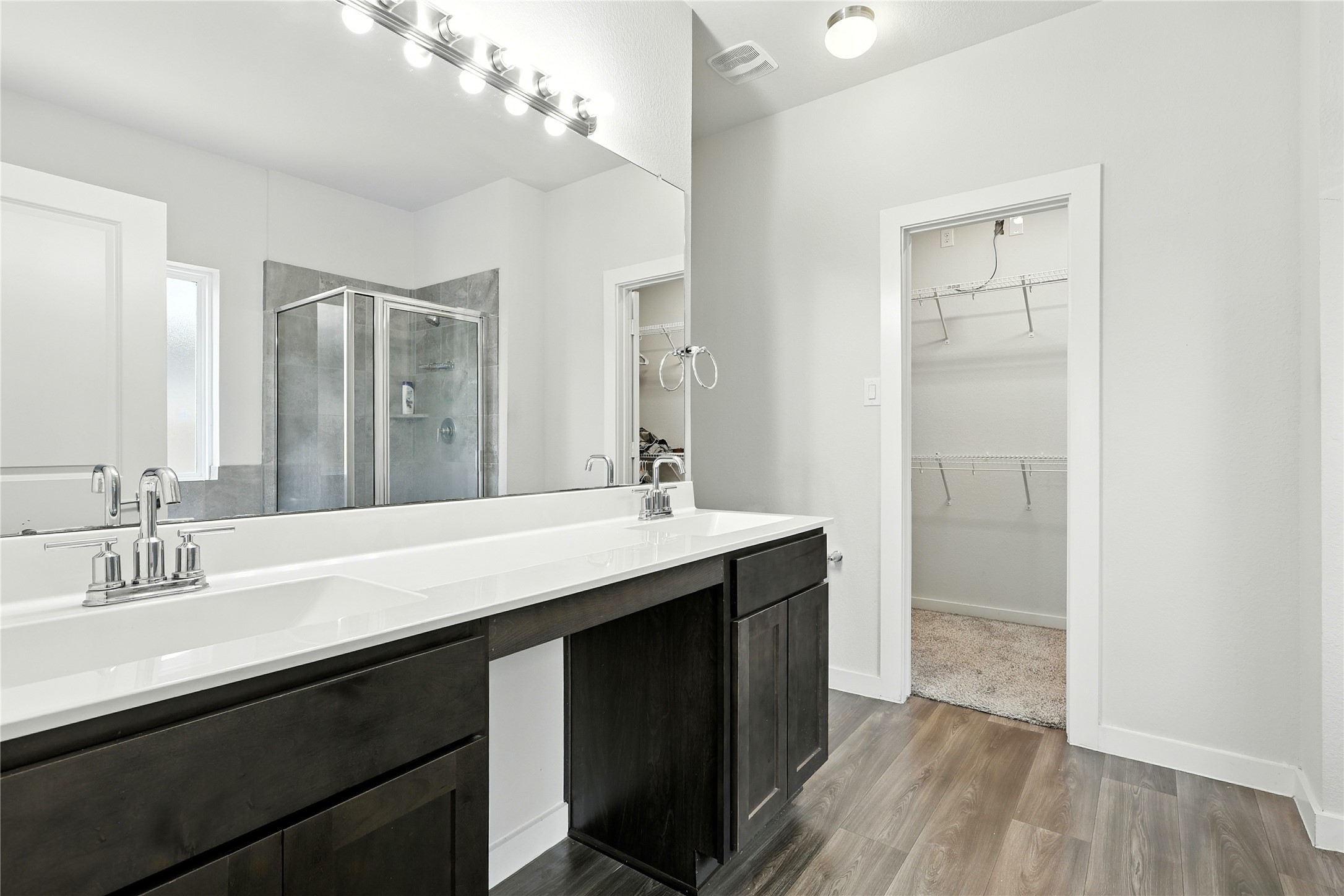 21319 Indigo Ruth Drive Spring, TX 77379 - Photo 12 of 34 a bathroom with a double vanity sink a mirror and a shower