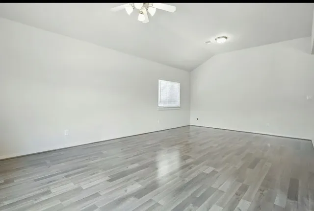 a view of an empty room and wooden floor
