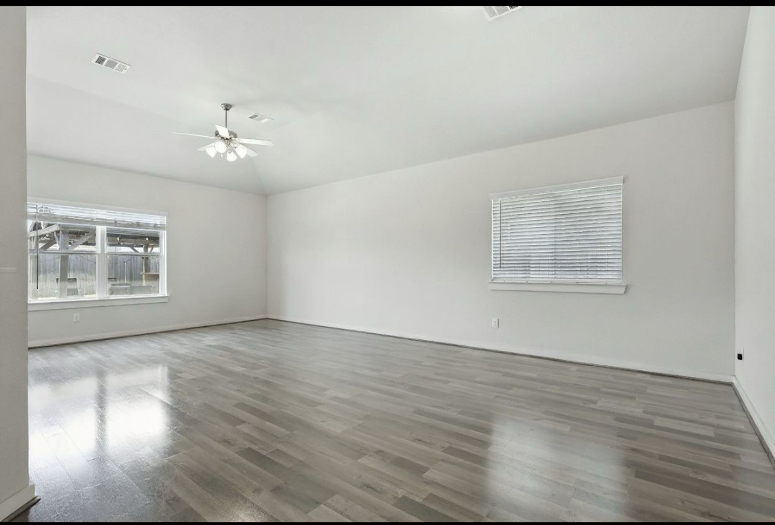 21319 Indigo Ruth Drive Spring, TX 77379 - Photo 17 of 34 wooden floor in an empty room with a window