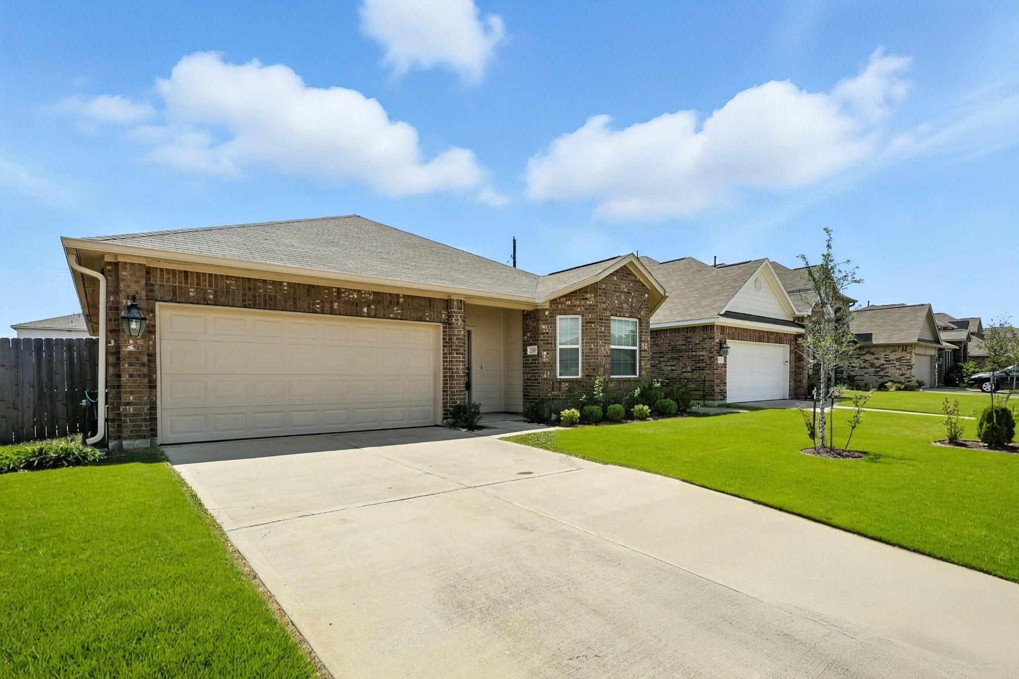 21319 Indigo Ruth Drive Spring, TX 77379 - Photo 2 of 34 a front view of a house with a yard and garage