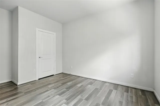 a view of an empty room and wooden floor