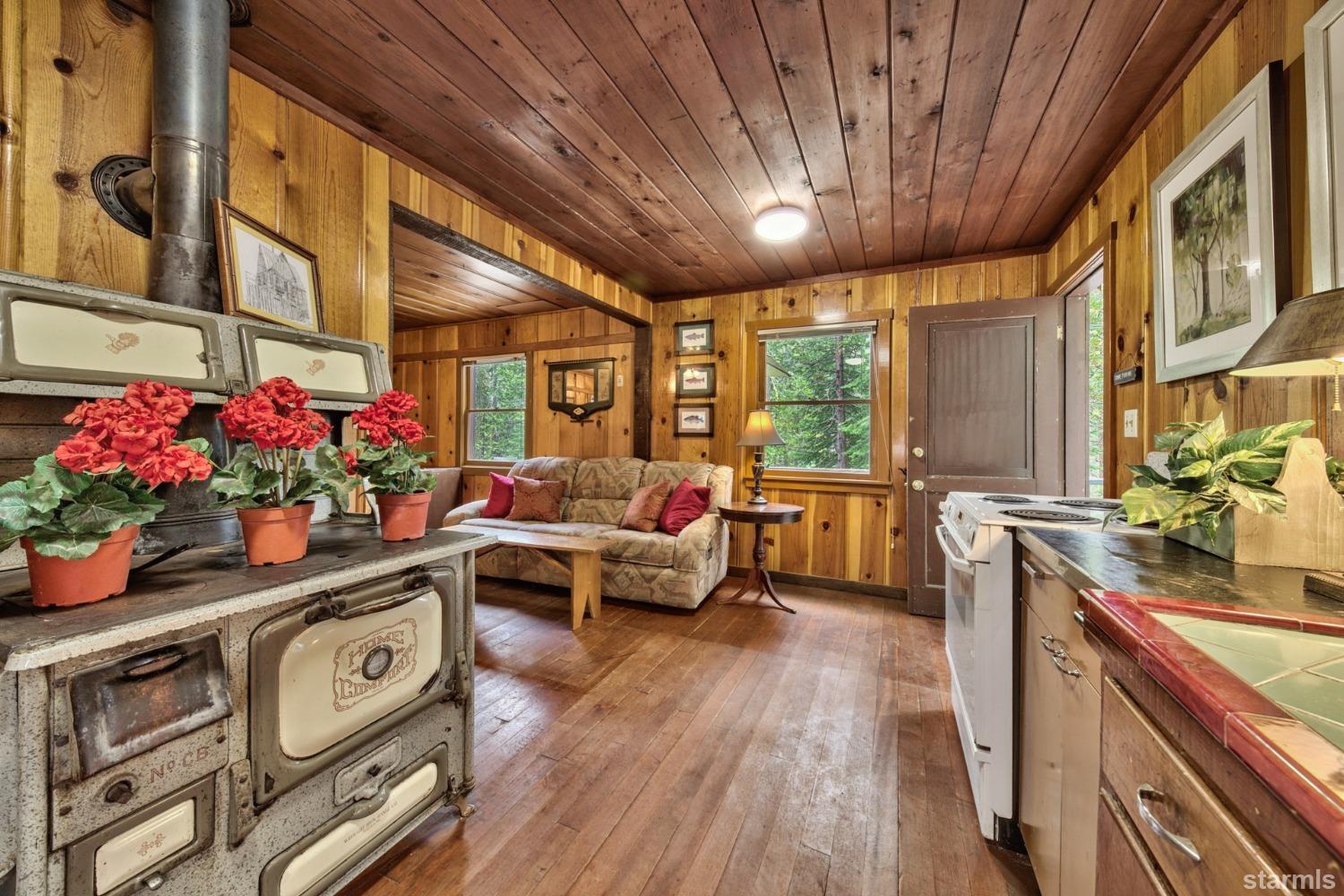 39 Milestone Road, Unit 32 Kyburz, CA 95720 - Photo 15 of 21 a living room with furniture and a chandelier