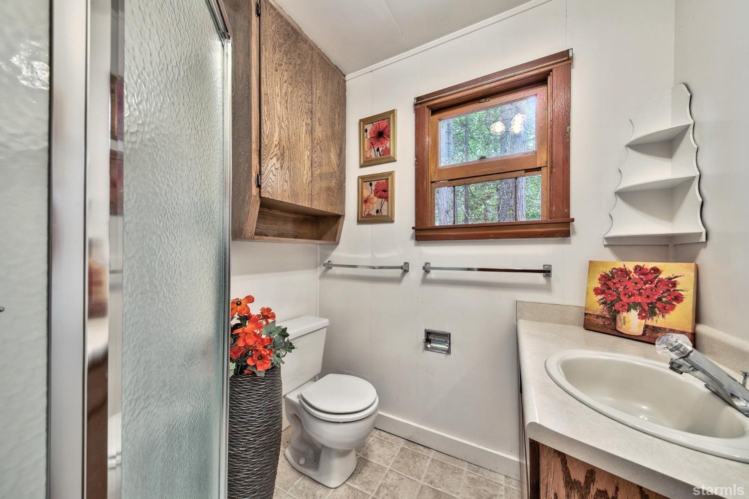 39 Milestone Road, Unit 32 Kyburz, CA 95720 - Photo 17 of 21 a bathroom with a toilet sink and mirror